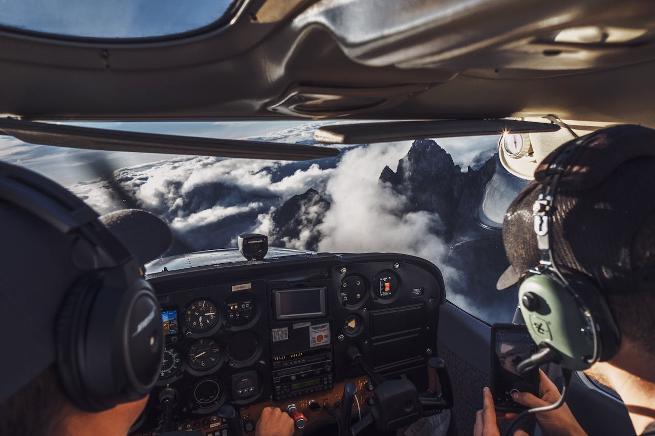 Pilot's perspective of flying over clouds and mountains, capturing the breathtaking view.